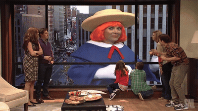 A Group Of People Looking Out A Window With Snl Written On It GIF