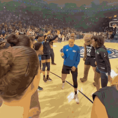 A Group Of People On A Basketball Court With A Mascot Wearing A Lynx 99 Jersey GIF