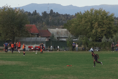 A Group Of People On A Field With One Wearing A Blue Shirt That Says ' Soccer ' On It GIF