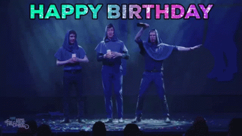 A Group Of People On A Stage With The Words Happy Birthday Written Above Them GIF