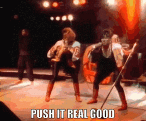 A Group Of People On A Stage With The Words Push It Real Good On The Bottom GIF