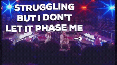 A Group Of People On A Stage With The Words " Struggling But I Don 'T Let It Phase Me " Above Them GIF