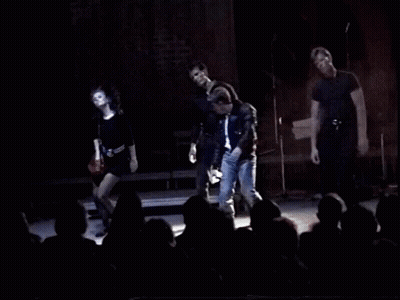 A Group Of People On Stage With The Words You 'Re Playin ' With Fire GIF
