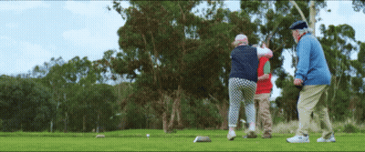 A Group Of People Playing Golf On A Green GIF
