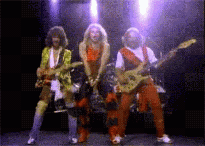A Group Of People Playing Guitars On Stage GIF