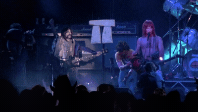 A Group Of People Playing Instruments On A Stage With Marshall Amps In The Background GIF