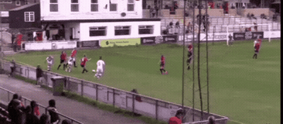A Group Of People Playing Soccer On A Field With A Building In The Background That Says ' Kappa ' GIF
