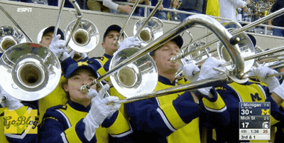 A Group Of People Playing Trombones With The Espn Logo On The Bottom Right GIF