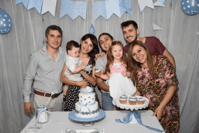 A Group Of People Pose In Front Of A Cake And Cupcakes GIF