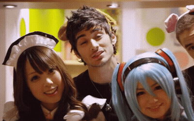 A Group Of People Posing For A Picture Including One Wearing A Maid Outfit GIF
