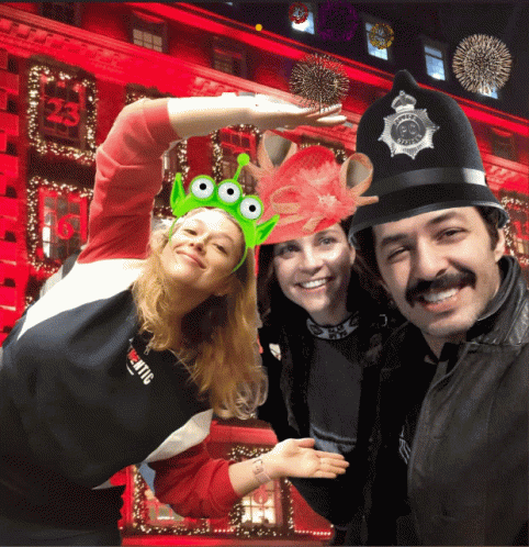 A Group Of People Posing For A Picture With One Wearing A Hat With The Number 23 On It GIF