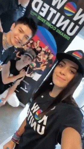 A Group Of People Posing For A Picture With One Wearing A Shirt That Says ' United ' On It GIF