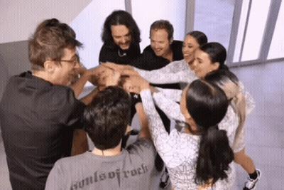 A Group Of People Putting Their Hands Together And One Of Them Has A Shirt That Says Souls Of Rock On It GIF