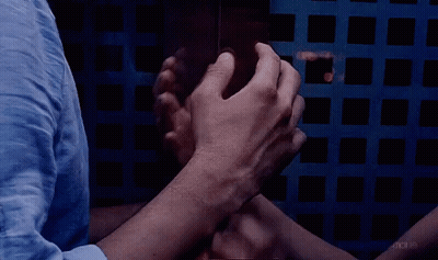A Group Of People Putting Their Hands Together In A Circle GIF