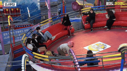 A Group Of People Riding A Roller Coaster With A Sign That Says Dj GIF
