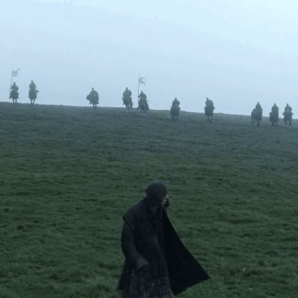 A Group Of People Riding Horses On A Hillside GIF