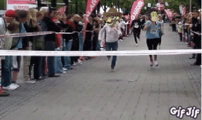 A Group Of People Running A Race With A Banner That Says Glamour GIF