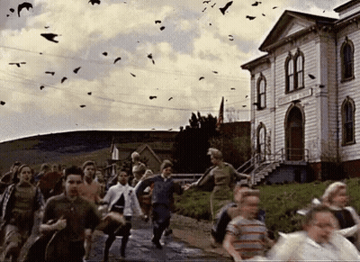 A Group Of People Running In Front Of A Building With Birds Flying In The Background GIF