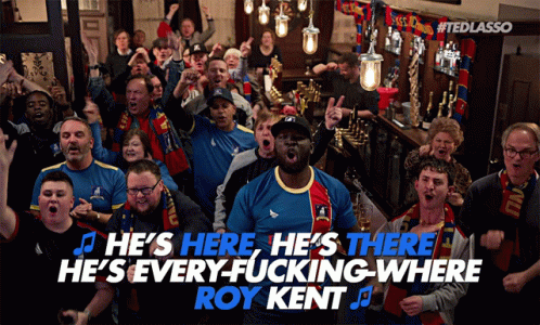 A Group Of People Singing He 'S Here He 'S There He 'S Everywhere Where Roy Kent GIF