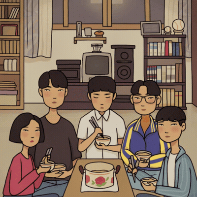 A Group Of People Sitting Around A Table With Bowls Of Food GIF