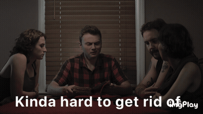 A Group Of People Sitting Around A Table With Something You Can 'T See Play Written In White Letters GIF