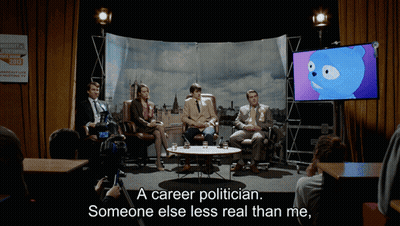 A Group Of People Sitting Around A Table With The Words " A Career Politician Someone Else Less Real Than Me " On The Bo GIF