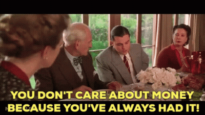 A Group Of People Sitting Around A Table With The Words You Don 'T Care About Money GIF
