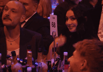 A Group Of People Sitting At A Table With Bottles Of Moet Champagne GIF