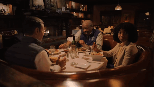 A Group Of People Sitting At A Table With The Words I 'M Jokin ' Written On The Bottom GIF