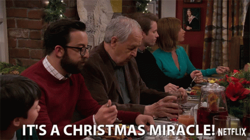 A Group Of People Sitting At A Table With The Words It 'S A Christmas Miracle Netflix On The Bottom GIF