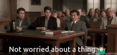 A Group Of People Sitting At A Table With The Words " Not Worried About A Thing " On The Bottom GIF