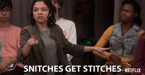 A Group Of People Sitting In A Room With The Words Snitches Get Stitches Netflix GIF