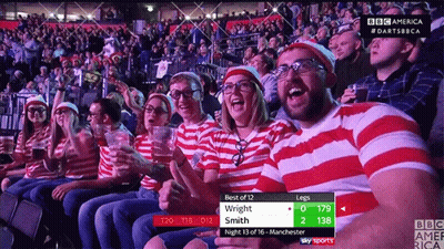 A Group Of People Sitting In A Stadium Watching A Game With A Scoreboard That Says Best Of 12 Wright Smith GIF