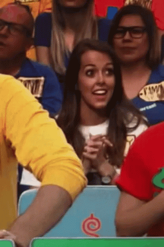 A Group Of People Sitting In A Stadium With One Wearing A Shirt That Says ' I Love You ' GIF