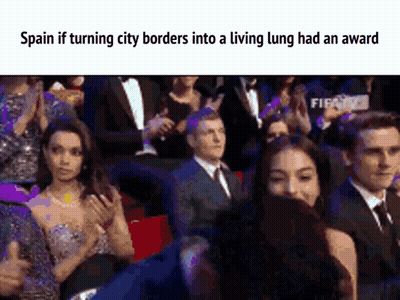A Group Of People Sitting In A Stadium With The Caption Spain If Turning City Borders Into A Living Lung Had An Award . GIF