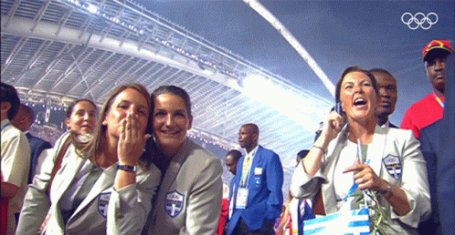 A Group Of People Sitting In A Stadium With The Olympics Logo On The Bottom GIF