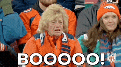 A Group Of People Sitting In A Stadium With The Words Booooo Written On The Screen . GIF