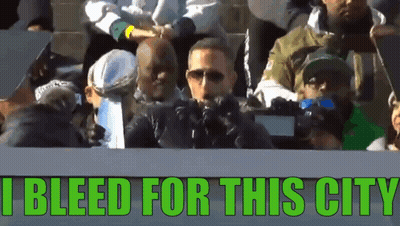 A Group Of People Sitting In A Stadium With The Words I Bleed For This City GIF