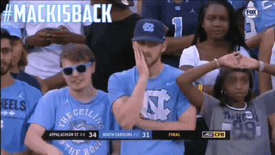 A Group Of People Sitting In A Stadium With The Words Mackisback On The Top GIF