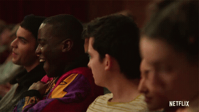 A Group Of People Sitting In A Theatre With A Netflix Logo On The Bottom GIF