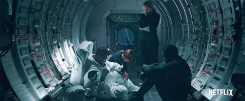 A Group Of People Sitting In A Tunnel With A Netflix Logo On The Bottom GIF