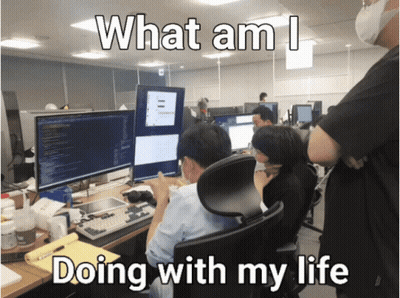 A Group Of People Sitting In Front Of Computer Monitors With The Words What Am I Doing With My Life Below Them GIF