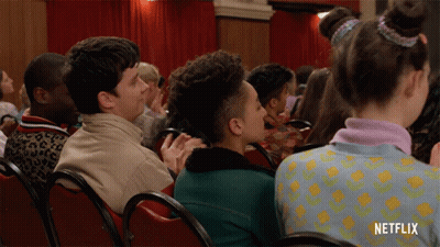 A Group Of People Sitting In Red Chairs With Netflix Written On The Bottom GIF