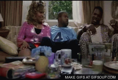A Group Of People Sitting On A Couch With A Man Wearing A Jersey With The Number 4 On It GIF