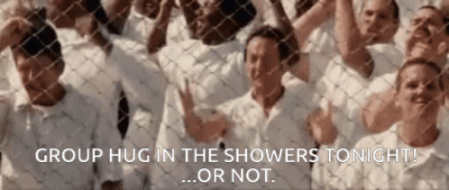 A Group Of People Standing Behind A Chain Link Fence With The Words Group Hug In The Showers Tonight Or Not GIF