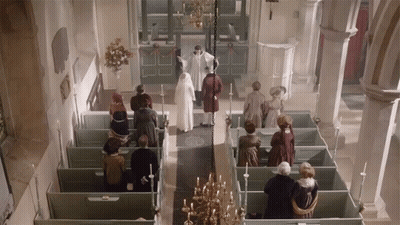 A Group Of People Standing In A Church With A Priest GIF