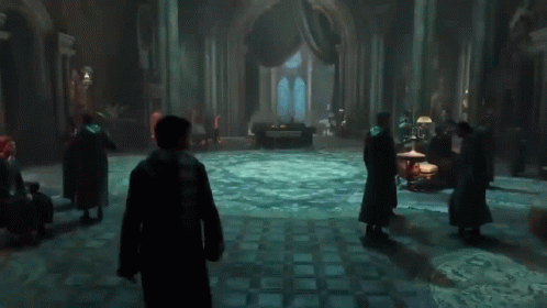 A Group Of People Standing In A Dark Room With A Circular Floor GIF