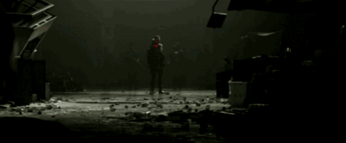 A Group Of People Standing In A Dark Room With A Red Light On Their Face GIF