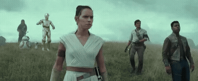 A Group Of People Standing In A Field With A C3po And Bb-8 In The Background GIF