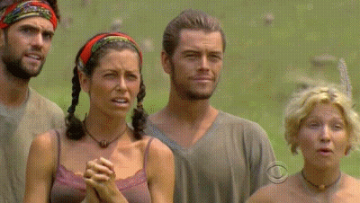 A Group Of People Standing In A Field With One Woman Wearing A Necklace That Says Cbs On It GIF